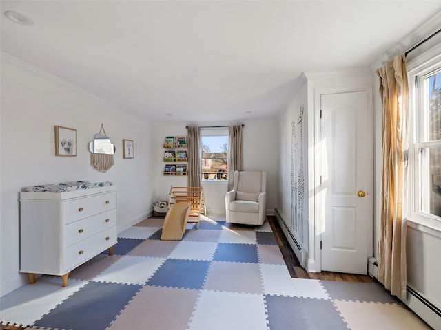 living area with baseboard heating and crown molding