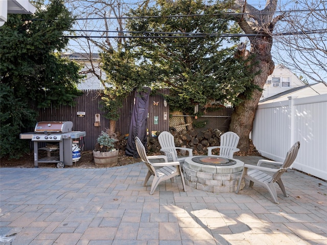 view of patio / terrace with an outdoor fire pit and a grill