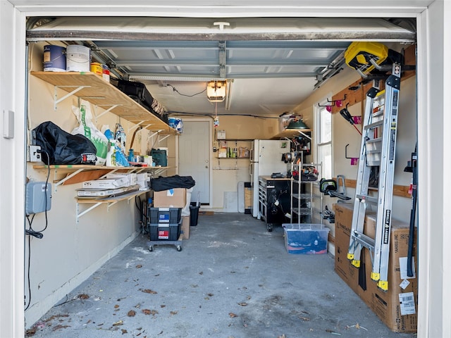 garage with white refrigerator and a garage door opener