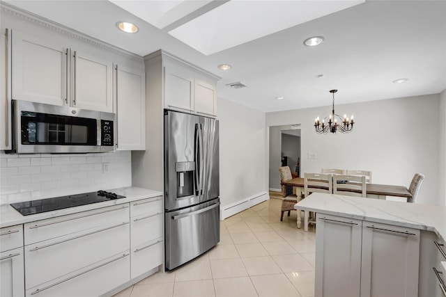 kitchen with white cabinetry, decorative backsplash, a baseboard heating unit, light tile patterned floors, and stainless steel appliances