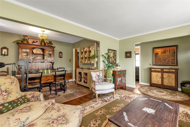 living room with wood-type flooring and crown molding