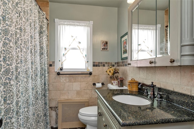 bathroom with vanity, toilet, and radiator heating unit