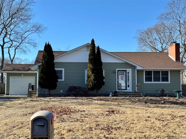 single story home with a garage and a front yard