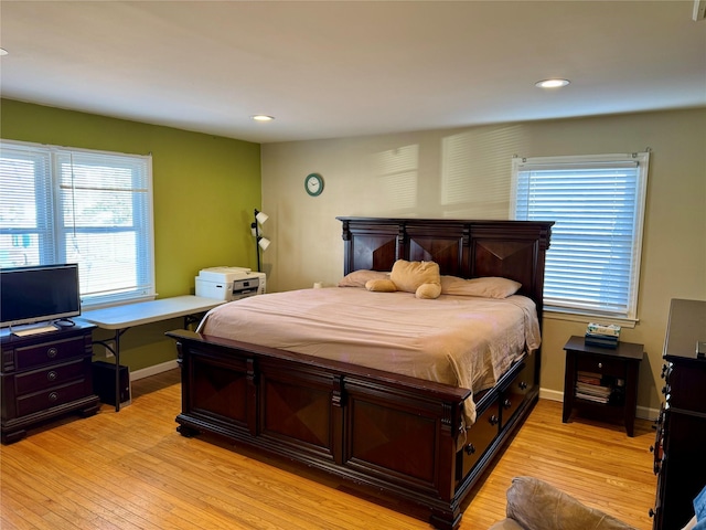 bedroom featuring baseboards, recessed lighting, and light wood-style floors