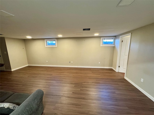 basement with recessed lighting, visible vents, dark wood finished floors, and baseboards