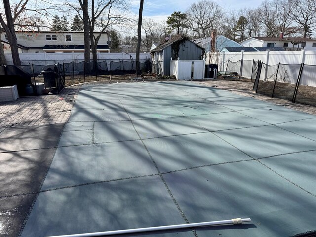 exterior space with a fenced backyard and a pool