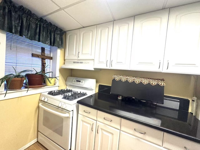 kitchen with white cabinetry, white range with gas stovetop, and a drop ceiling