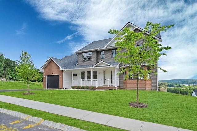 craftsman-style house featuring a garage, a front lawn, and a porch