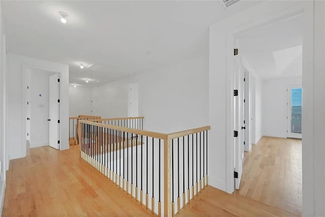 hallway with hardwood / wood-style flooring