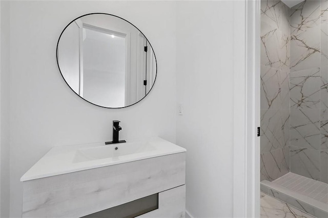 bathroom with vanity and a tile shower