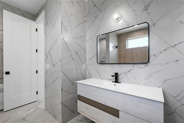 bathroom with vanity and tile walls