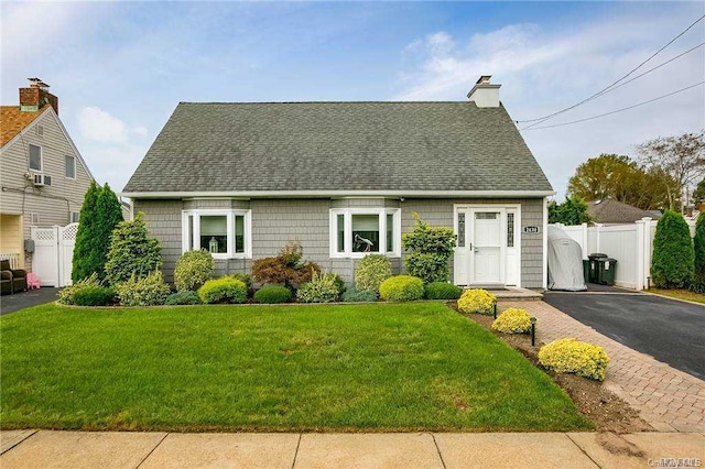 new england style home featuring a front yard