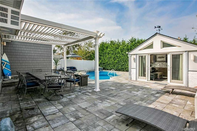 view of patio featuring a fenced in pool, an outdoor structure, and a pergola