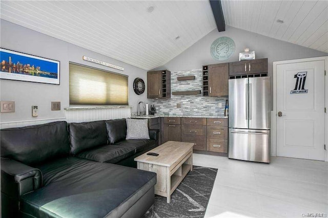 living room featuring sink and lofted ceiling with beams