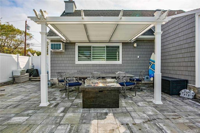 view of patio / terrace featuring an AC wall unit, a grill, and a fire pit