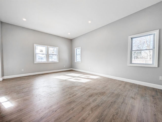 unfurnished room with hardwood / wood-style flooring