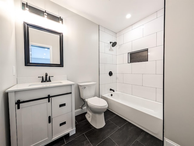 full bathroom featuring tile patterned floors, tiled shower / bath combo, vanity, and toilet