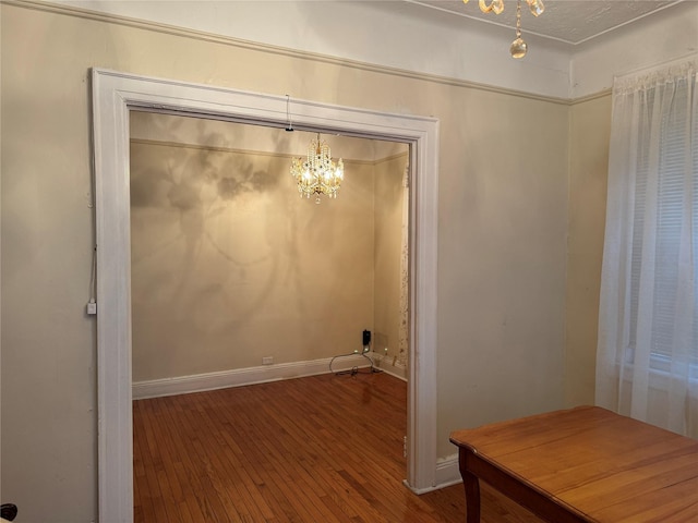 interior space featuring hardwood / wood-style floors and a notable chandelier