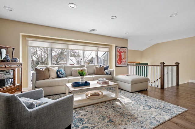 living room with hardwood / wood-style floors and vaulted ceiling