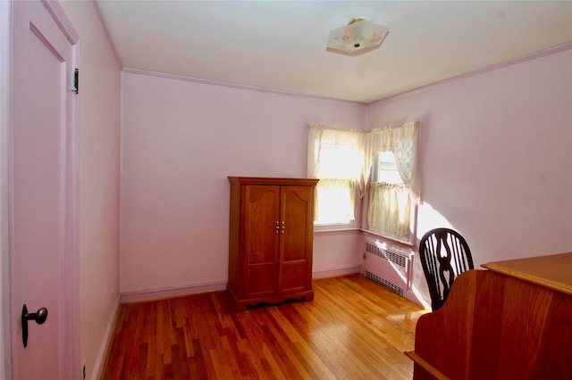 interior space with light hardwood / wood-style flooring and radiator