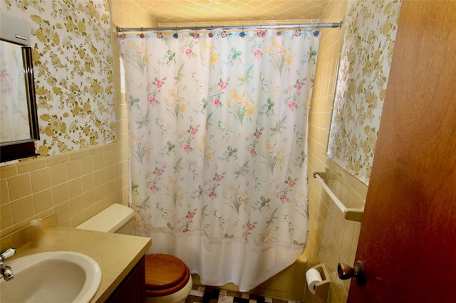 bathroom featuring tile walls, toilet, vanity, and a shower with curtain