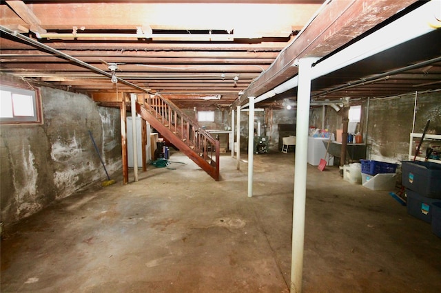 basement featuring water heater and washer / clothes dryer