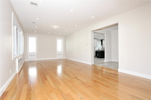 spare room with light hardwood / wood-style flooring