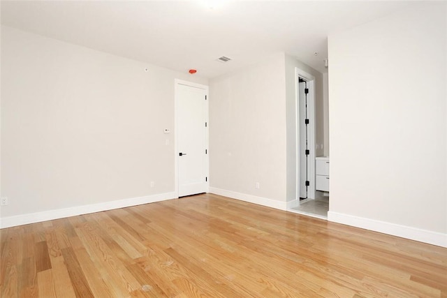 spare room featuring wood-type flooring