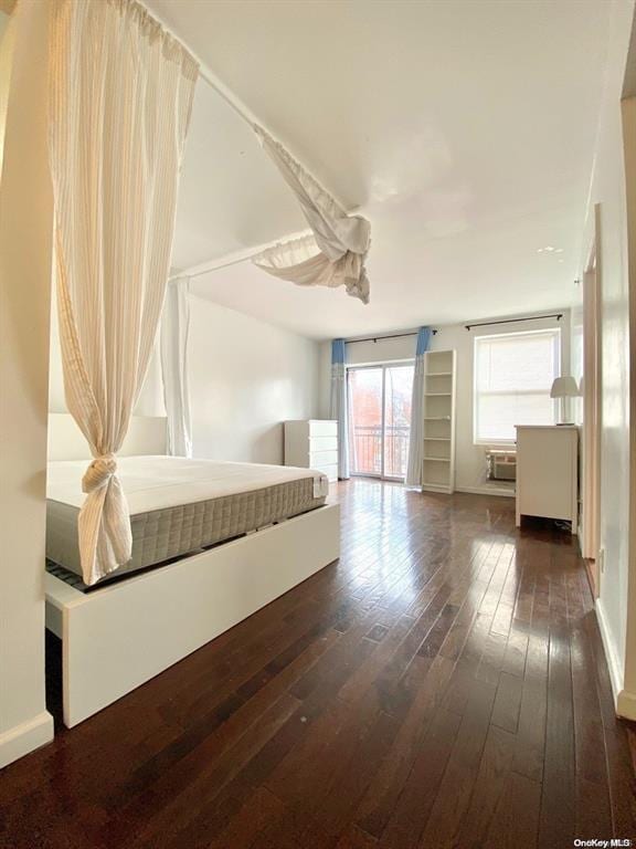 unfurnished bedroom with ceiling fan and dark hardwood / wood-style flooring