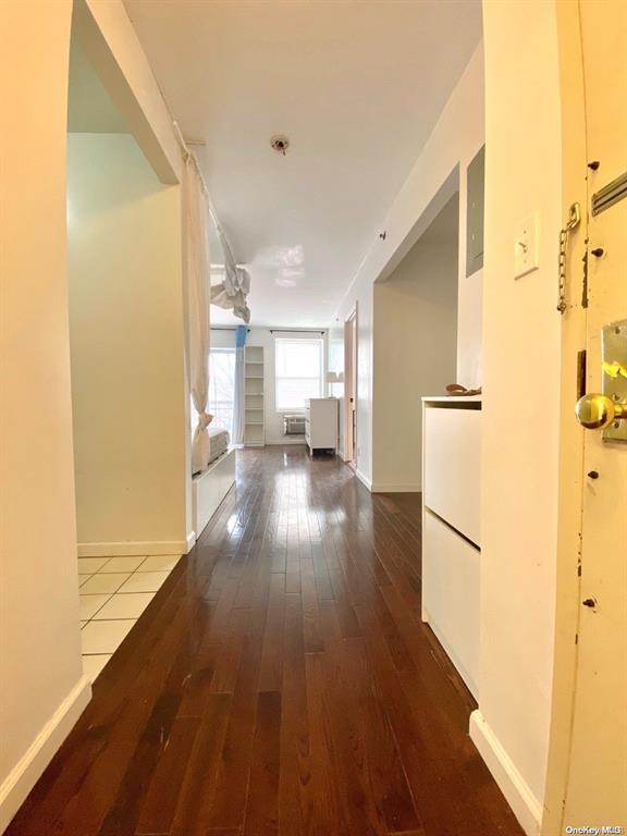 hallway with hardwood / wood-style floors