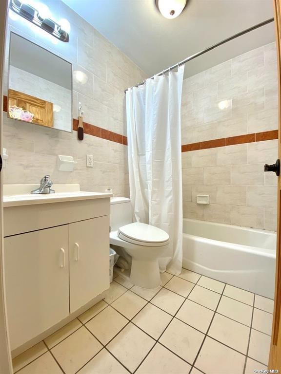 full bathroom with tile walls, tile patterned floors, toilet, and shower / bathtub combination with curtain