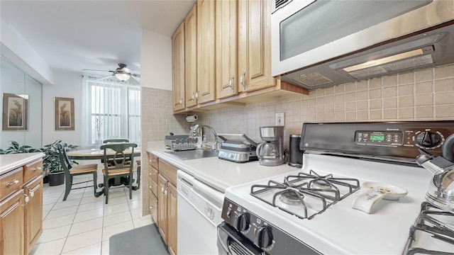 kitchen with white appliances, decorative backsplash, sink, ceiling fan, and light tile patterned flooring