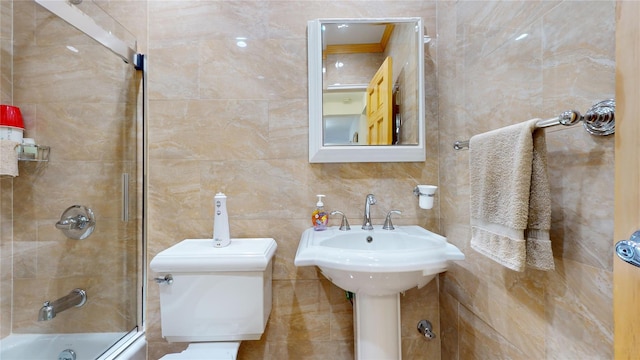 full bathroom featuring sink, toilet, and tiled shower / bath