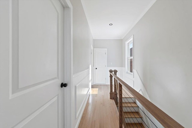 hall featuring crown molding and light hardwood / wood-style flooring