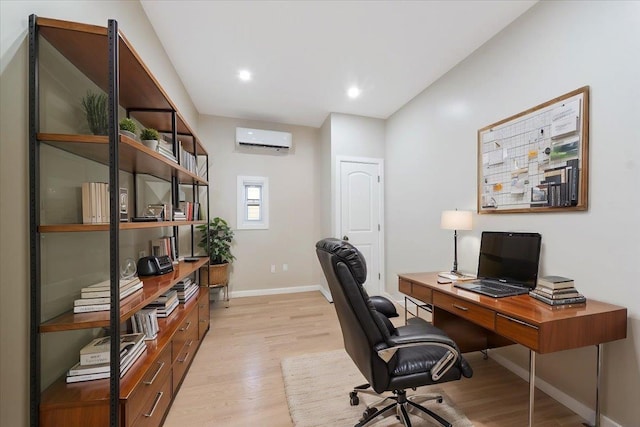 office featuring light wood-type flooring and a wall mounted air conditioner