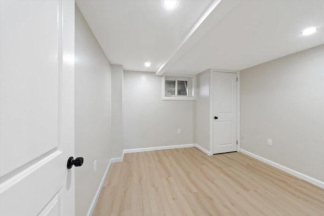 basement with light hardwood / wood-style floors