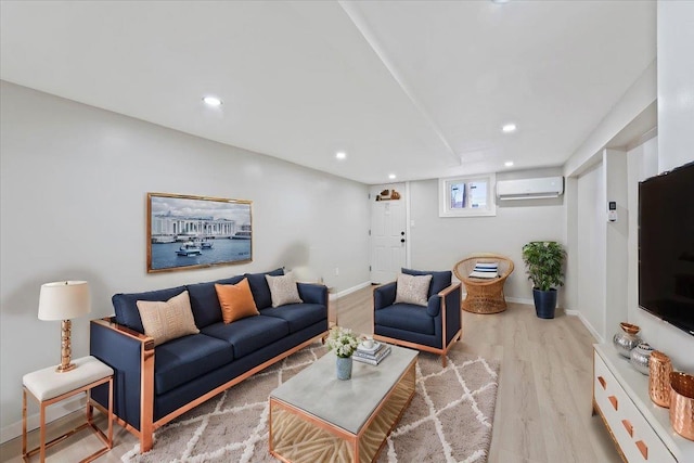 living room with light hardwood / wood-style flooring and a wall unit AC