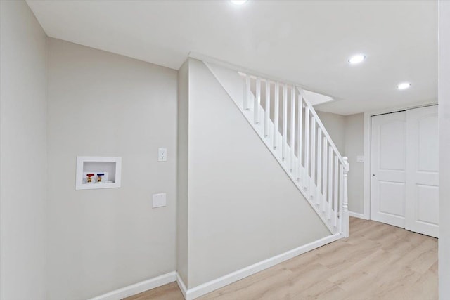 interior space with light hardwood / wood-style floors and hookup for a washing machine