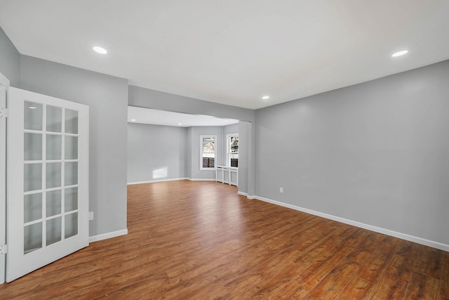 unfurnished living room featuring hardwood / wood-style flooring