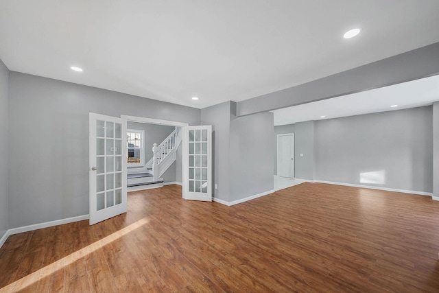 empty room featuring french doors and hardwood / wood-style floors