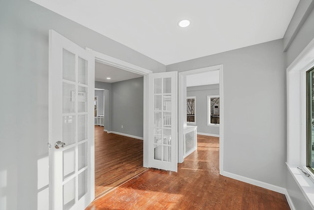 unfurnished room featuring hardwood / wood-style floors and french doors