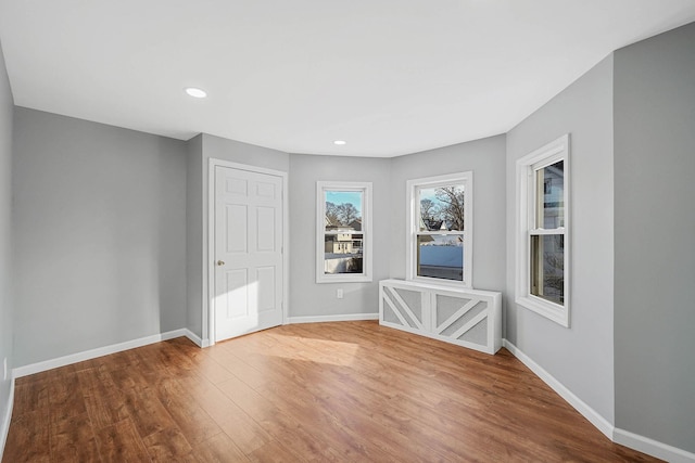 unfurnished room with wood-type flooring