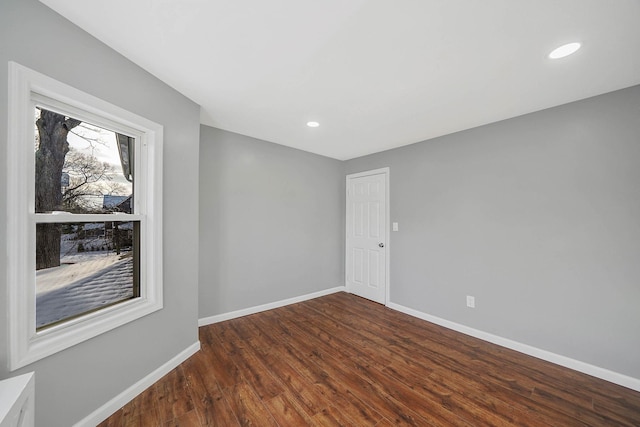 spare room with dark hardwood / wood-style floors