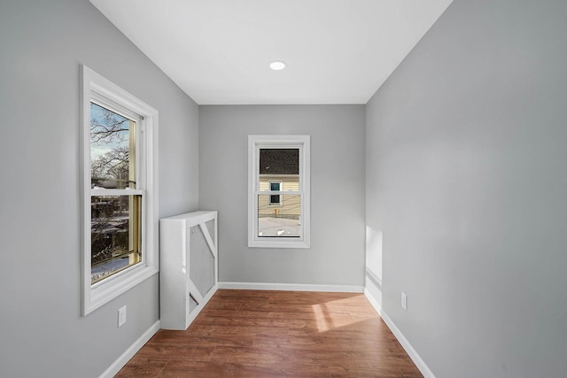 unfurnished room featuring hardwood / wood-style flooring and plenty of natural light