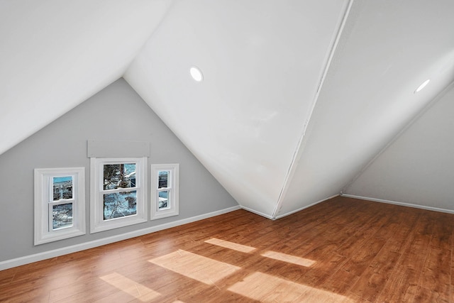 additional living space featuring hardwood / wood-style floors and lofted ceiling