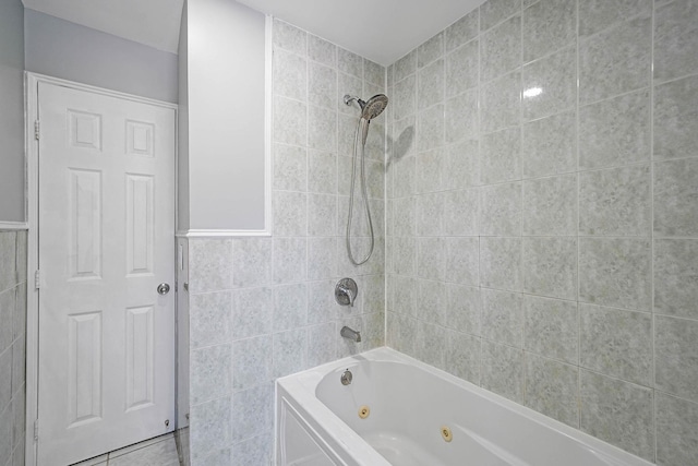 bathroom with tile patterned floors and tiled shower / bath combo