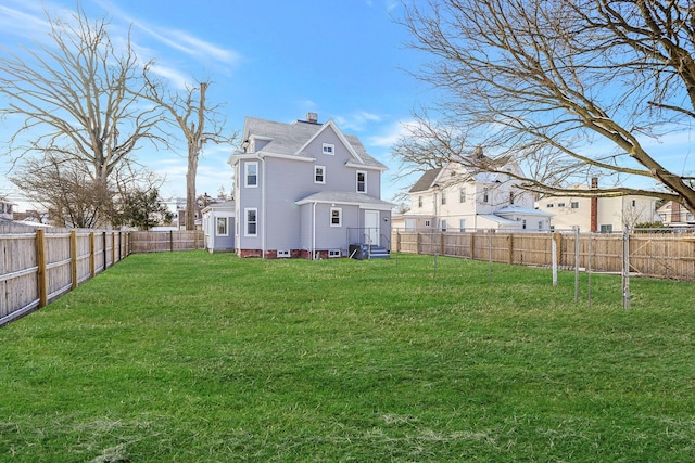 rear view of property featuring a yard