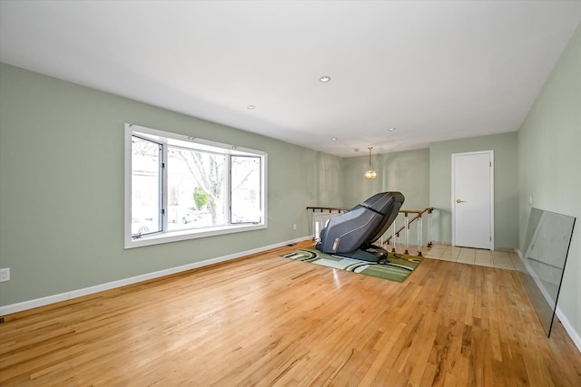 exercise room with light wood-type flooring