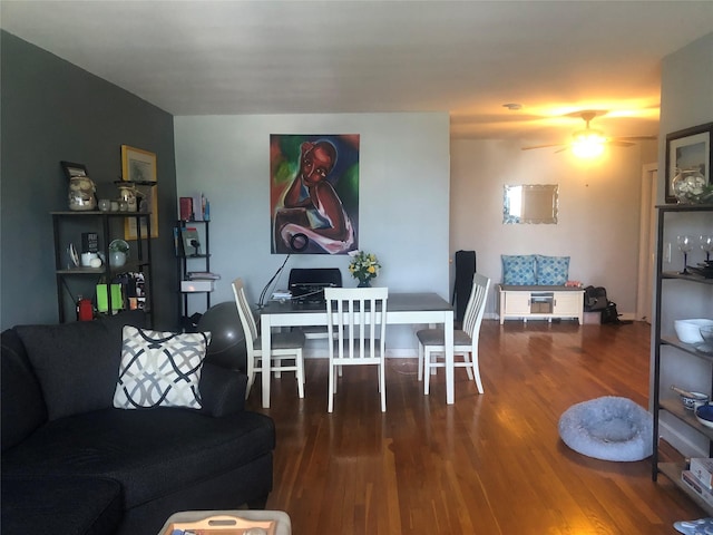 dining space with hardwood / wood-style floors and ceiling fan