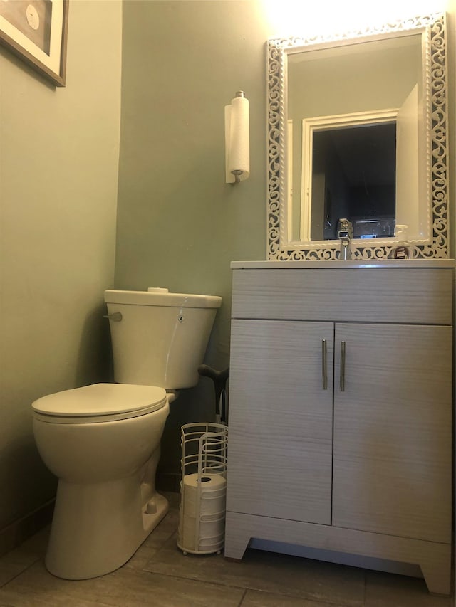 bathroom featuring vanity, wood-type flooring, and toilet